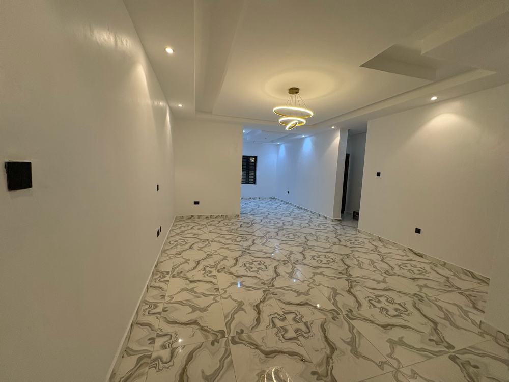 Living area with marble floor tiles and a ring chandelier